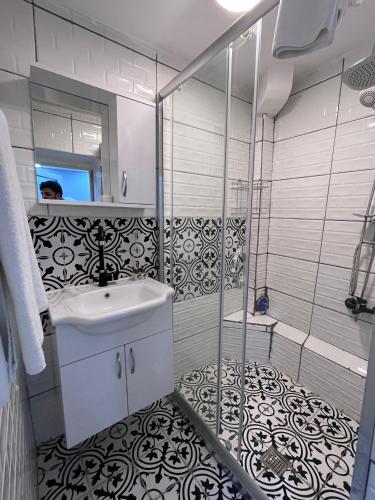 a bathroom with a shower and a sink and a mirror at LİFE APART- basement in Istanbul