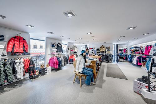 a man sitting in a chair in a clothing store at Hotel Nevada in Samnaun