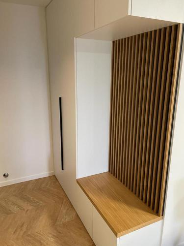 a room with a white wall with a wooden shelf at APPARTMENTS SARA in Jadranovo