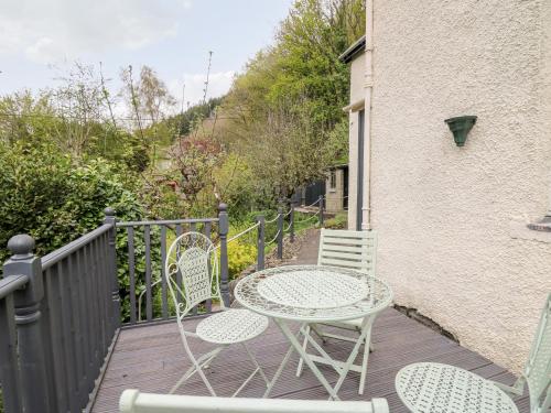 a table and chairs sitting on a deck at Myrtle Villa in Knighton