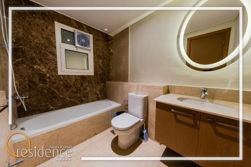 a bathroom with a toilet and a sink and a mirror at Luxury apartments in Mivida new cairo in New cairo