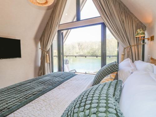 a bedroom with two beds and a large window at Lakeside Lodge in Wolverhampton