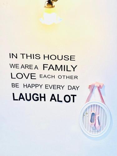 a sign that says in this house we are a family love each other be happy at Casa Angiolina - Holidays in Morcote