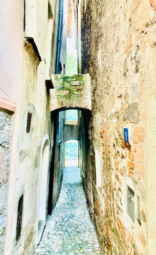 an alley way between two buildings in a city at Casa Angiolina - Holidays in Morcote