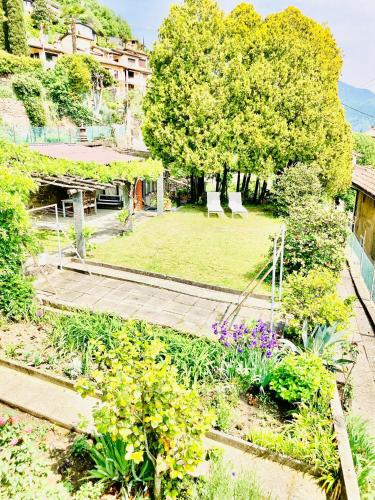 a view of a garden with flowers and trees at Casa Angiolina - Holidays in Morcote