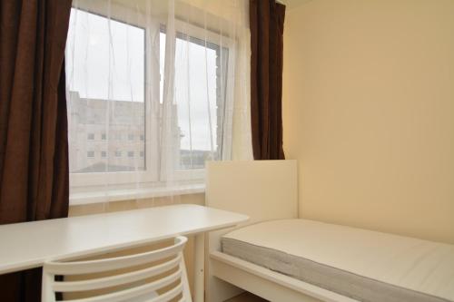 een kleine kamer met een bureau en een raam bij Vytauto av 9 - Kaunas Students Home LT in Kaunas