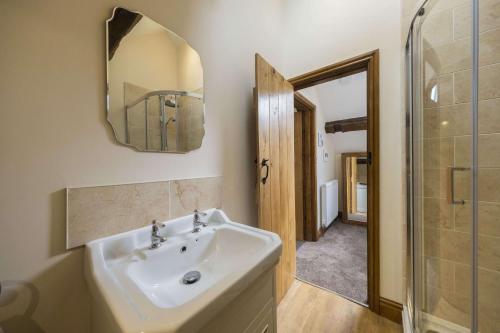 a bathroom with a sink and a shower and a mirror at The Hoglets 2 in Goostrey