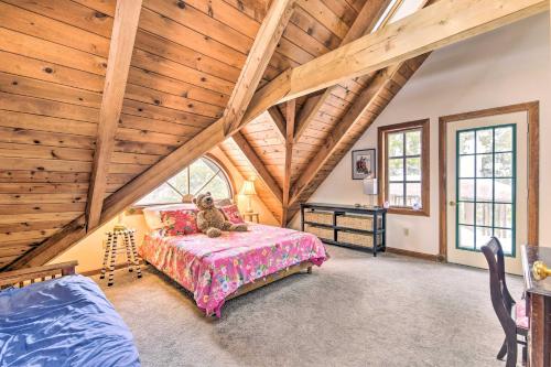 a bedroom with a bed with a teddy bear on it at Waitsfield Vacation Rental with Private Hot Tub in Waitsfield