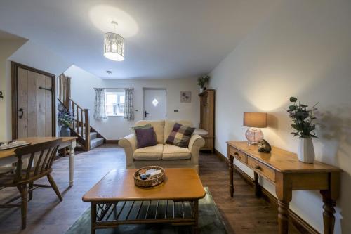 a living room with a couch and a table at The Hoglets 3 in Goostrey