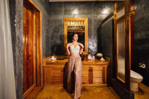 a woman standing in front of a sink in a bathroom at Andalay Beach Resort Koh Libong in Ko Libong