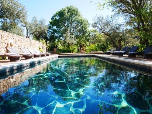 a swimming pool with chaise lounge chairs in a backyard at Serra Vida - A Place Of Presence in Santo António das Areias