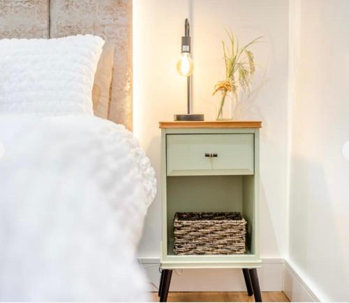 a bedroom with a bed and a nightstand with a white bed at Newly renovated Stables conversion in Burstwick