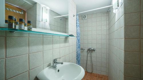 a bathroom with a sink and a mirror at Villa Niki in Loutro