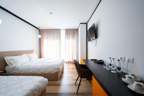 a hotel room with a bed and a desk at Royal G Max in Golem