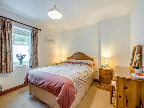a bedroom with a bed and a window at Little Springfield in Hayle