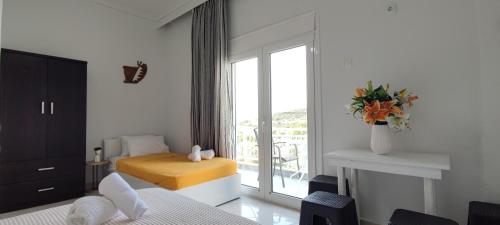 a hotel room with a bed and a window at Wave Sound Apartments - Beach View in Skala Marion