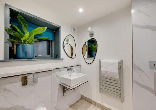 a bathroom with a sink and a mirror at The Barn at The Foldyard in Holme upon Spalding Moor