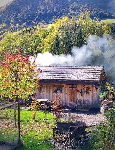 a small cabin with smoke coming out of it at Chalet trappeur in Le Biot
