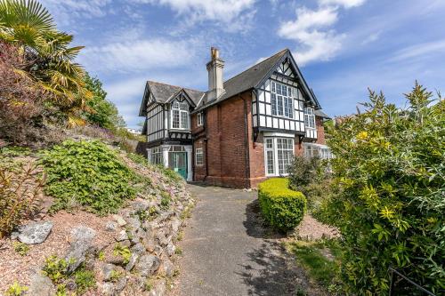 a black and white house with a driveway at The Torcroft Apartments at Bedford House in Torquay