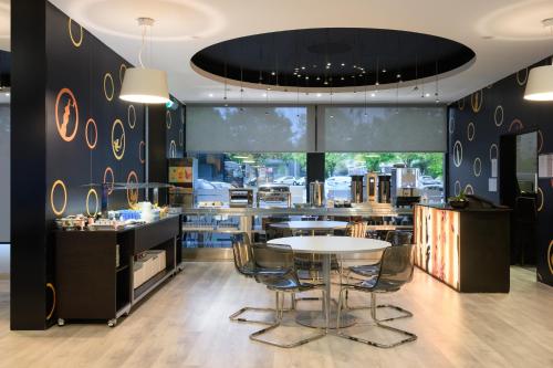 a restaurant with a table and chairs in a room at Star Inn Porto in Porto