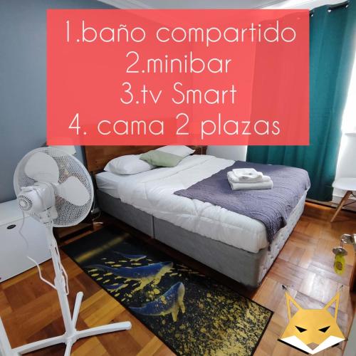 a bedroom with a bed and a fan on the floor at HOSTAL SUZI in Santiago
