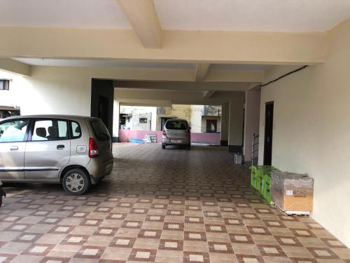a car parked in a parking lot in a garage at Tirumala Elite Homestay (near Railway station & Bustand) in Tirupati