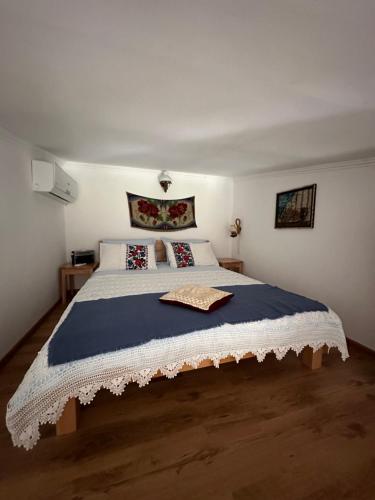 a bedroom with a large bed with a blue blanket at Samothraki - sea, mountain, quiet in Palaiopoli