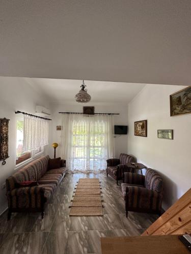 a living room with couches and a large window at Samothraki - sea, mountain, quiet in Samothráki
