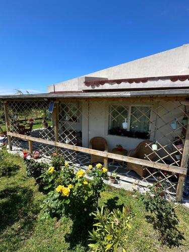 a house with a fence and flowers in front of it at Samothraki - sea, mountain, quiet in Samothráki