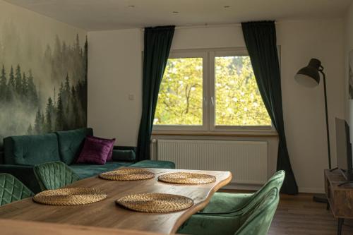 a dining room table with chairs and a large window at Die entspannendste Wohnung am Edersee - SPA Sauna in Giflitz