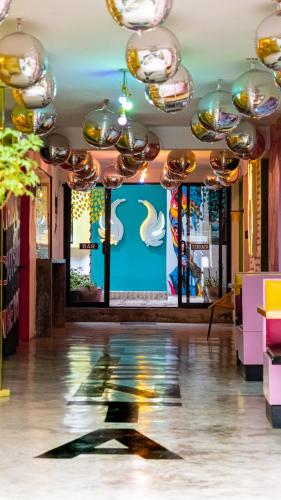 a room with a large screen with a painting on the wall at Hotel Suculenta Boutique in San Cristóbal de Las Casas
