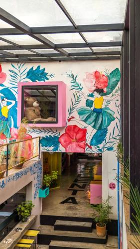 a hallway with a mural of flowers on the wall at Hotel Suculenta Boutique in San Cristóbal de Las Casas