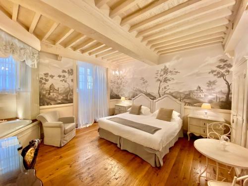 a bedroom with a bed and a painting on the wall at La Corte Di Ambra in Cortona