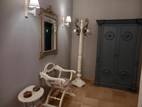 a room with a chair and a mirror and a cabinet at HOME Lagana' in Messina