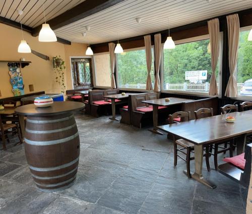 a restaurant with tables and chairs and windows at Ristorante della Stazione in Tegna
