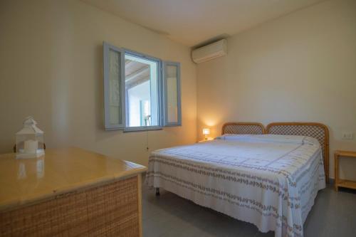 Postel nebo postele na pokoji v ubytování Villetta Capo Bianco - HelloElba