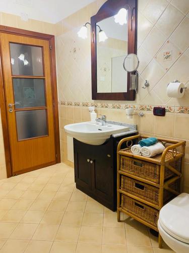 a bathroom with a sink and a toilet and a mirror at Stella Maris Holidays, Large Terrace, 5 min Beach, Amalfi Coast in Maiori