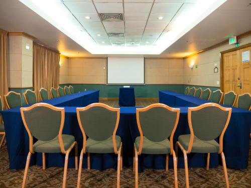 a conference room with a blue table and chairs at Holiday Inn Express Torreon by IHG in Torreón