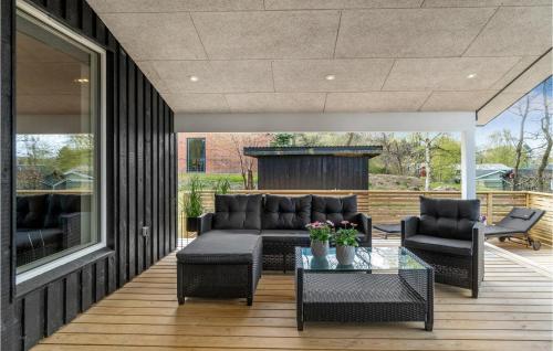 a patio with a couch and two chairs and a table at Cozy Home In Fårvang With Wifi in Fårvang