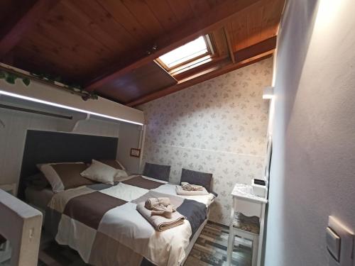1 dormitorio con 1 cama con toallas en La Casita, en Gijón