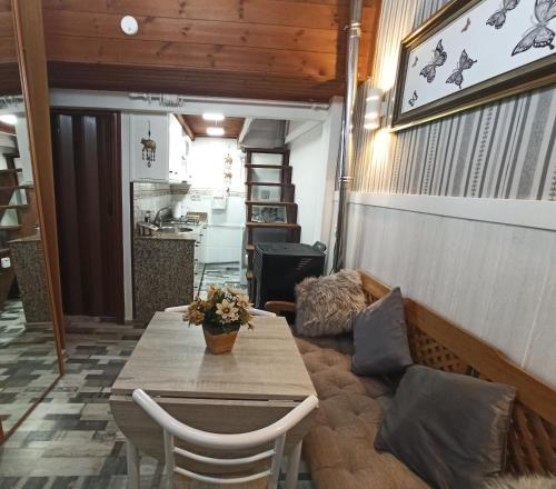 a living room with a table and a couch at La Casita in Gijón