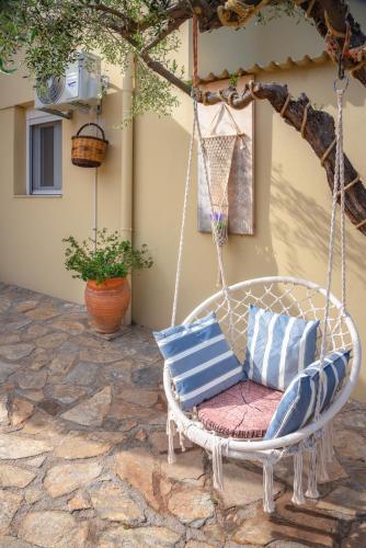 a porch swing with blue and white pillows on it at Princess Sissi, Villa-House with private pool and garden in Sissi