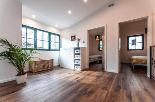 an empty living room with wooden floors and a refrigerator at Entire house in the center of Ljubljana - FREE PARKING - Dragon Garden Pavilion Ljubljana in Ljubljana