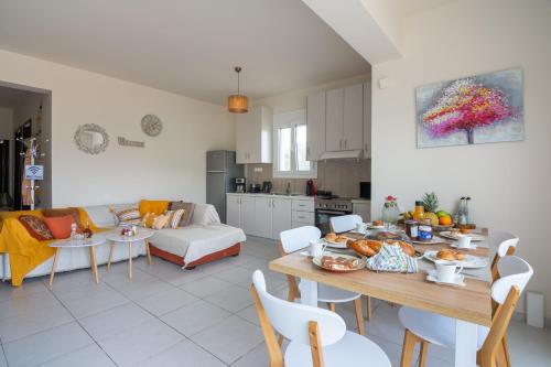 a kitchen and a living room with a table with food on it at Princess Sissi, Villa-House with private pool and garden in Sissi