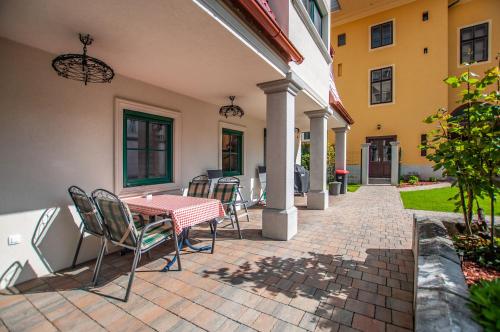 a patio with a table and chairs on a house at Entire house in the center of Ljubljana - FREE PARKING - Dragon Garden Pavilion Ljubljana in Ljubljana