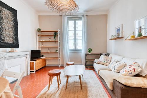 a living room with a couch and a fireplace at Cosy apartment located at 100 m from the beaches and the splendid corniche in Marseille