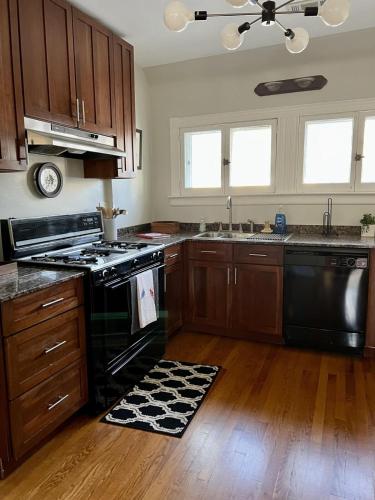 a kitchen with black appliances and wooden cabinets at Historic Oak Park Residence in Oak Park