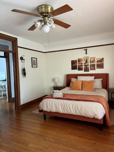 a bedroom with a bed with a ceiling fan at Historic Oak Park Residence in Oak Park