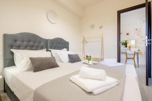 a white bedroom with a large bed with white pillows at Princess Sissi, Villa-House with private pool and garden in Sissi