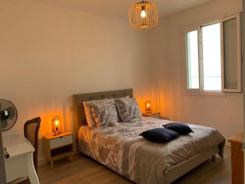 a bedroom with a bed with two pillows on it at Magnifique maison avec vue mer hauteur de Bastia in Bastia